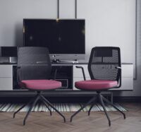 Pokój z dwoma krzesłami biurowymi z różowymi siedziskami na tle telewizora
